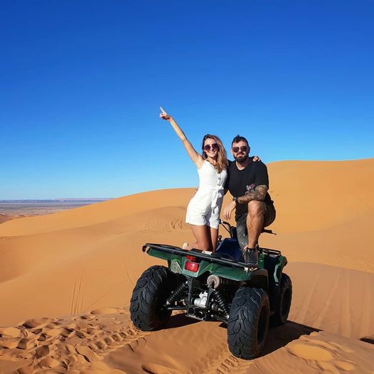 couple with quad bikingin sahara