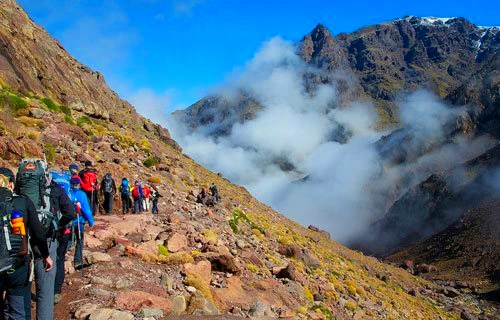 people trekking in high atlas mountains