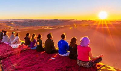 tourists enjoying sunset morocco sahara dunes