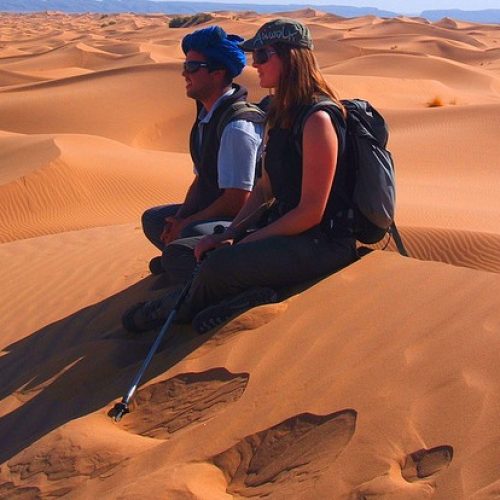 couple-sitting-in-sand-dunes