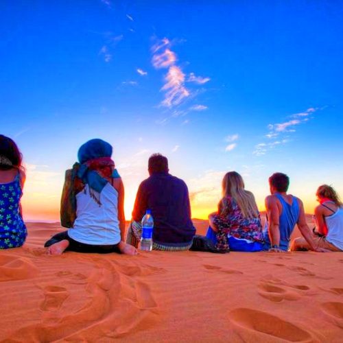 group of tourists enjoying desert