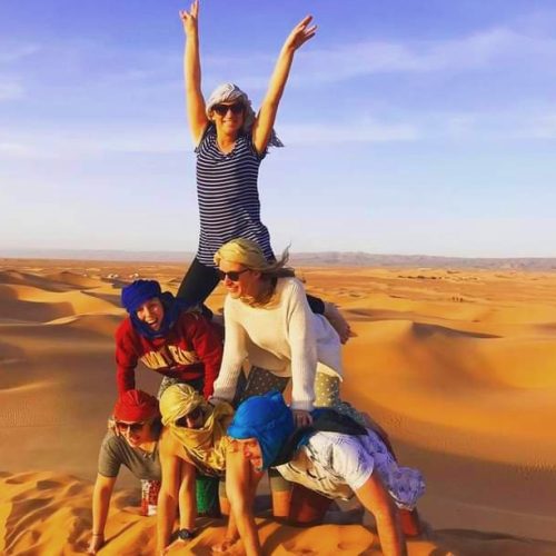 tourists playing in morocco desert