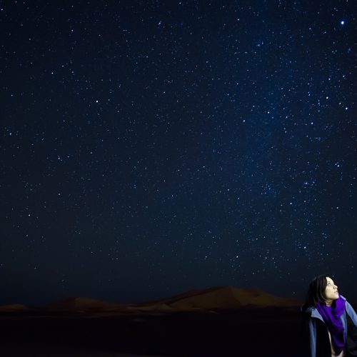 woman enjoying stars in sahara desert