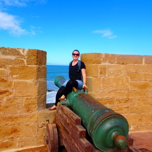 woman sitting on canon in essaouira fort