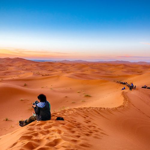 woman taking merzouga sand dunes photo
