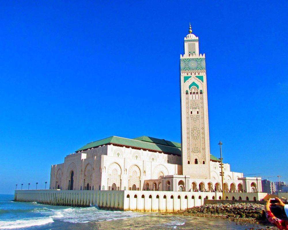 woman tourist taking picture of casablanca mosque